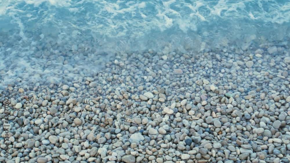 Splashing waves on a shore full of pebbles Splashing waves on a shore full of pebbles