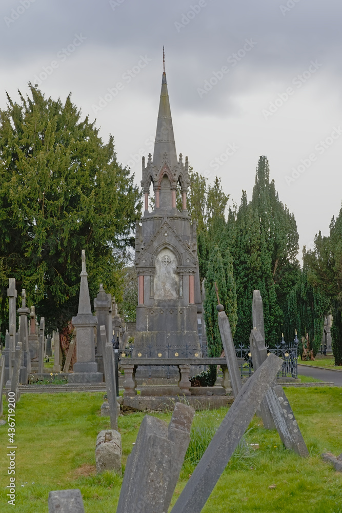 Old historic grave monuments with crosses in Glasnevin, green cemetery