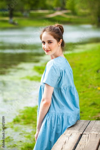 Fototapeta Naklejka Na Ścianę i Meble -  Young beautiful woman in turquoise dress