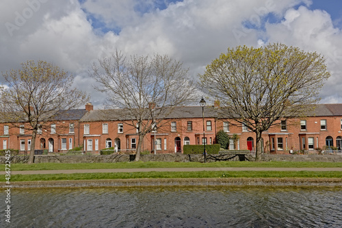 Photography Brickstone terraced houses Grand canal with green spring trees in Dublin, Ireland