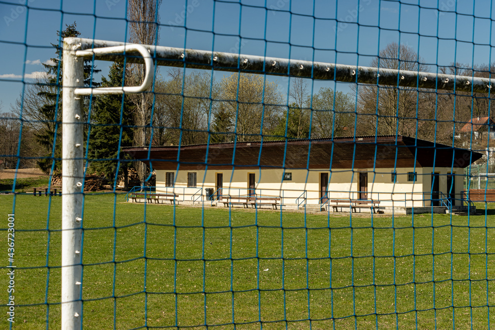 The provincial football playground with dressing room for player, view through the goal gate.