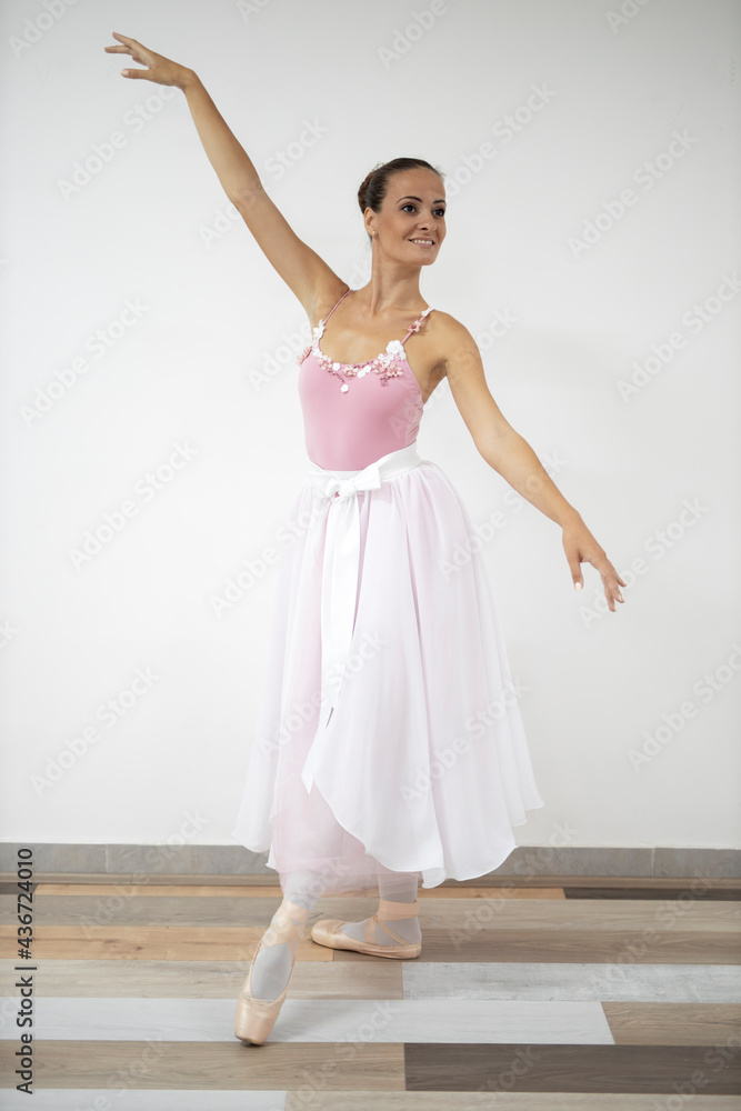 Beautiful professional ballerina in pink dress dance in ballet studio Beautiful professional ballerina in pink dress dance in ballet studio