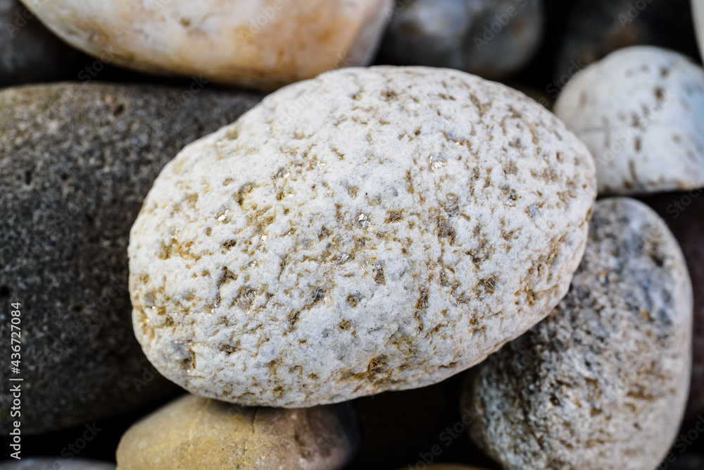 A large stone with pyrite grains between the stones. A large stone with pyrite grains between the stones.