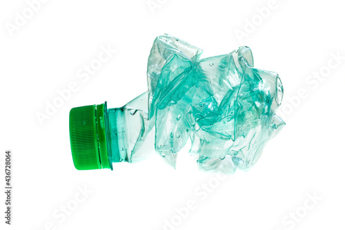 crumpled green plastic bottle on white isolated background
