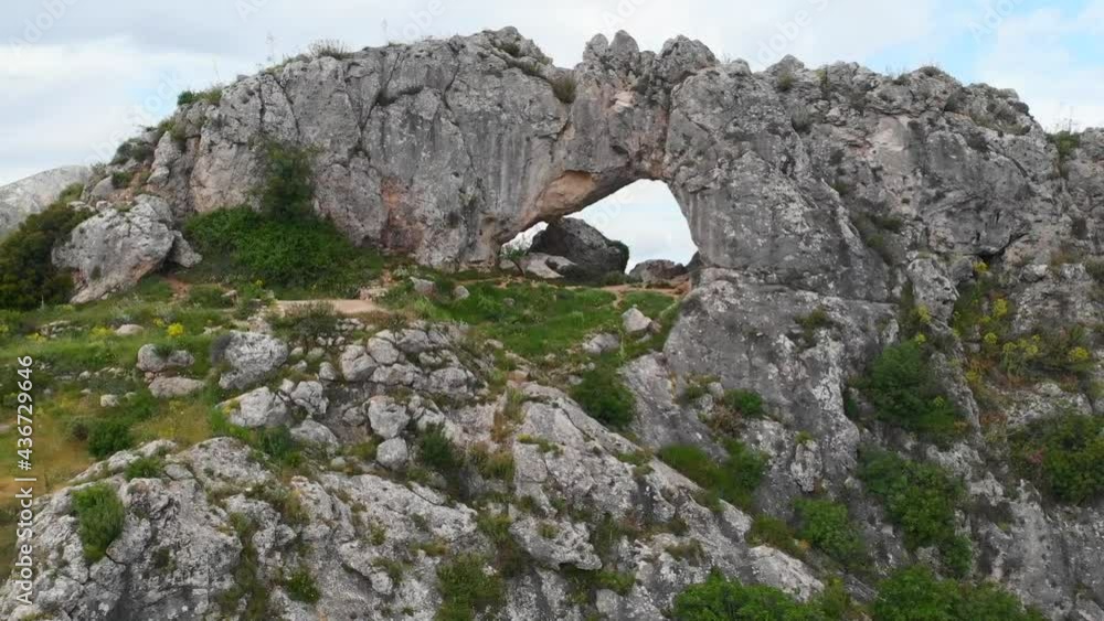 La Forada arch rock on the top of a mountain in La Vall de Gallinera valley, in Alicante, Spain. La Forada arch rock on the top of a mountain in La Vall de Gallinera valley, in Alicante, Spain.