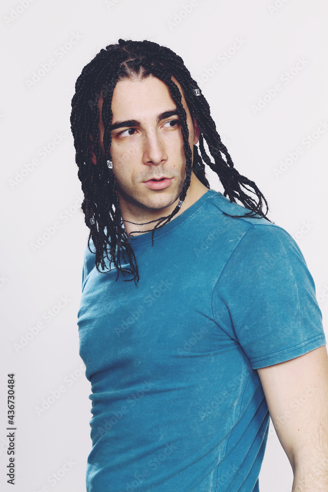 Stylish male model with afro braids posing in studio on isolated background. Style, trends, fashion concept. Stylish male model with afro braids posing in studio on isolated background. Style, trends, fashion concept.