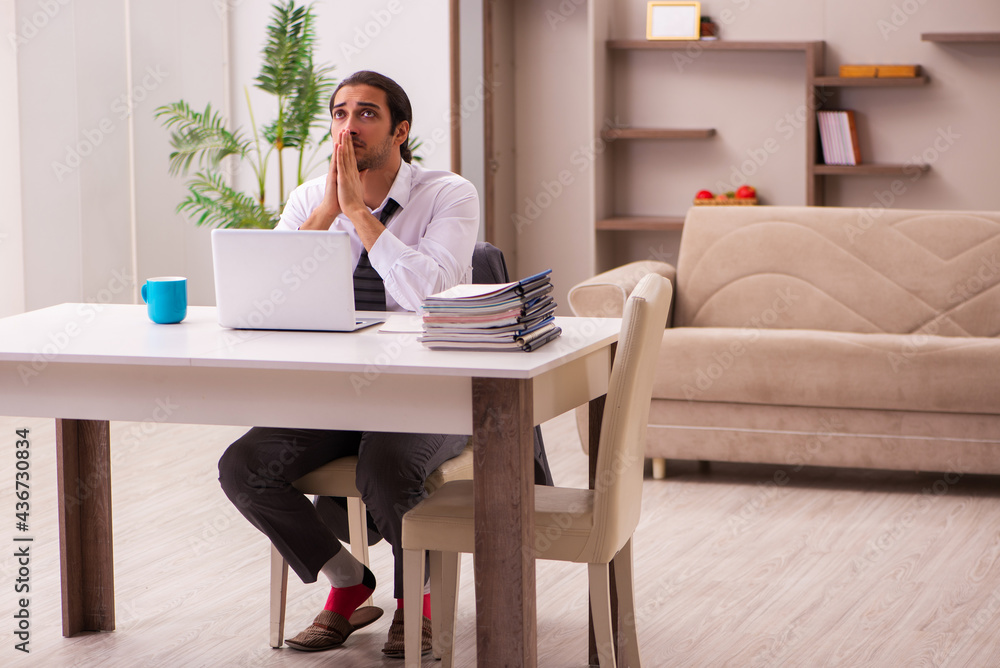 Young male employee working from home during pandemic Young male employee working from home during pandemic