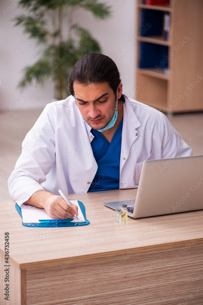 Young male doctor working in the clinic Young male doctor working in the clinic