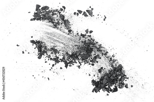 Activated charcoal powder for facial mask. Black charcoal particles on a white background.