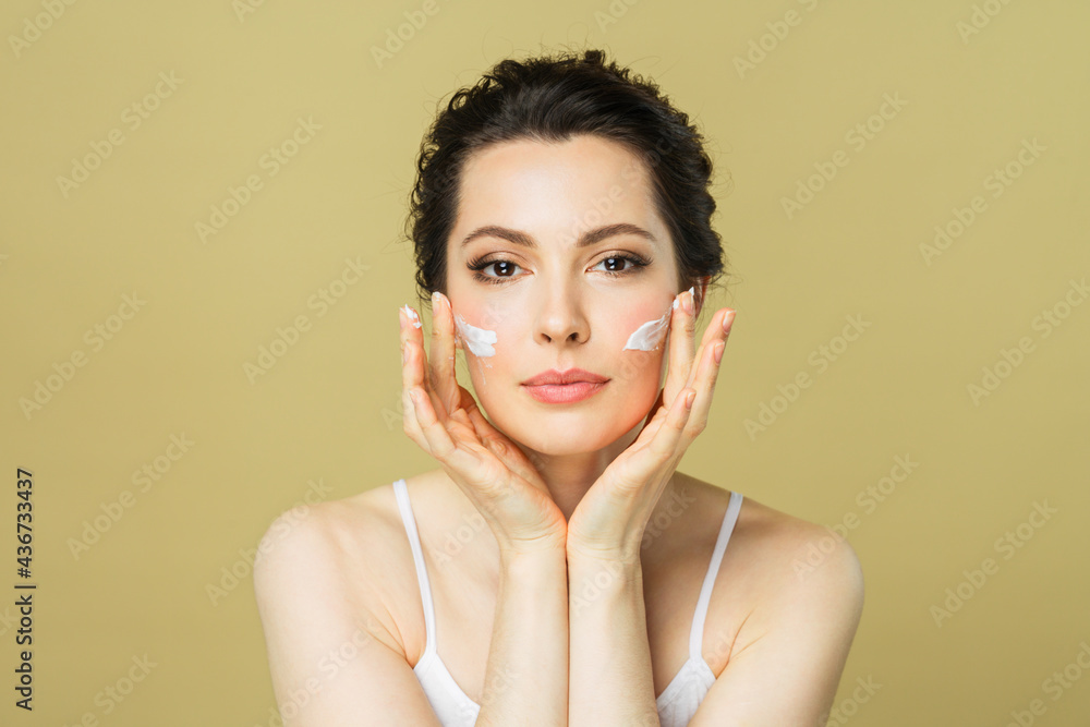 Happy beautiful woman holding her cheeks with a laugh looking to the side. Cosmetology, beauty Happy beautiful woman holding her cheeks with a laugh looking to the side. Cosmetology, beauty
