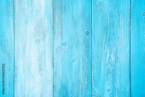 Natural wooden background painted in different tones of light blue color. Horizontal view.