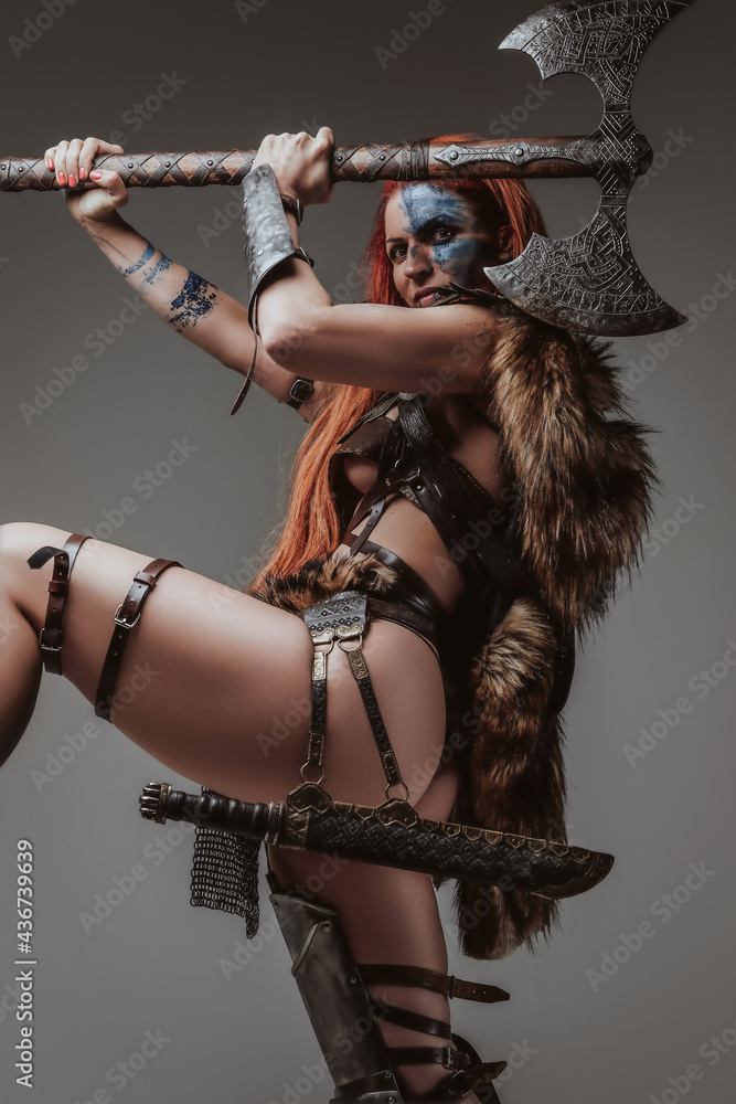 Sexy barbaric woman viking holding an axe above her head Stock Photo |  Adobe Stock