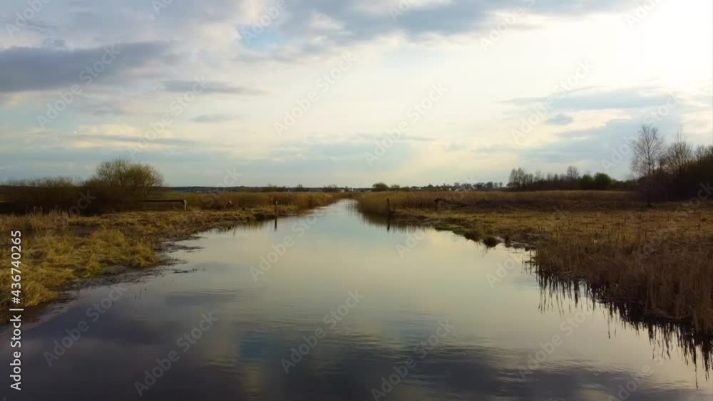 Smooth flight over a calm river at sunset Smooth flight over a calm river at sunset