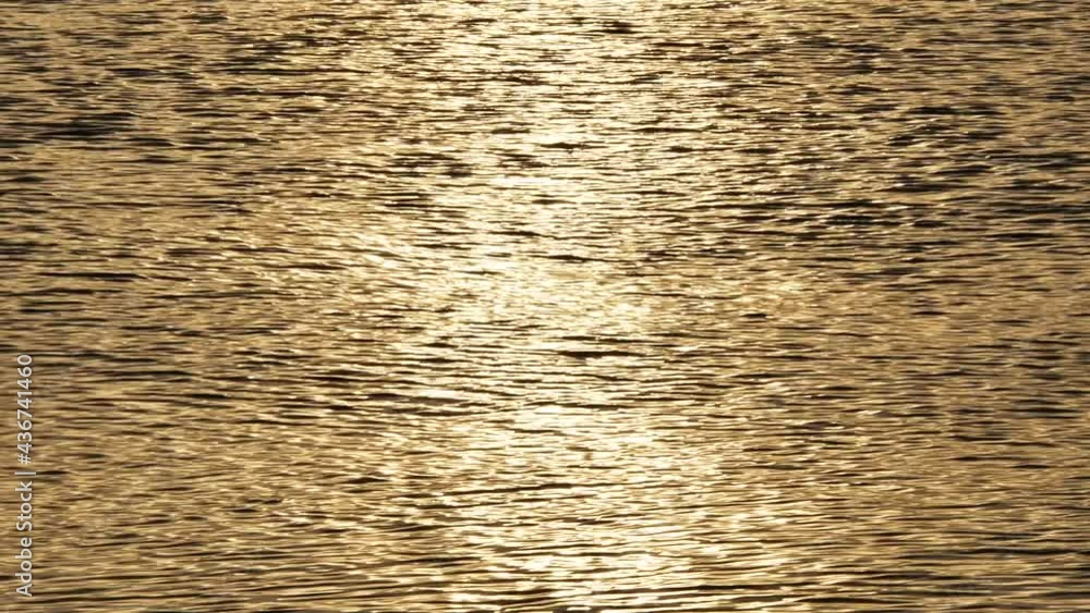 Ocean with gold water waves surface. Disturbed yellow ocean water surface background Ocean with gold water waves surface. Disturbed yellow ocean water surface background