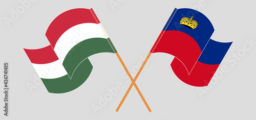 Crossed and waving flags of Hungary and Liechtenstein