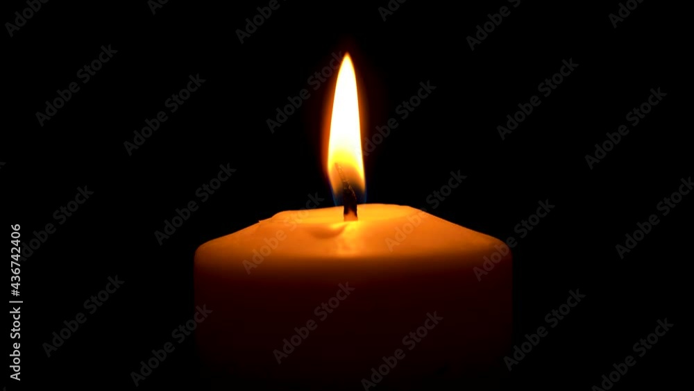 Lonely candle burns on a black background Lonely candle burns on a black background