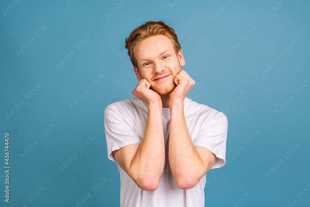 Portrait of attractive red-haired caucasian young man wearing casual, isolated on blue background. Portrait of attractive red-haired caucasian young man wearing casual, isolated on blue background.