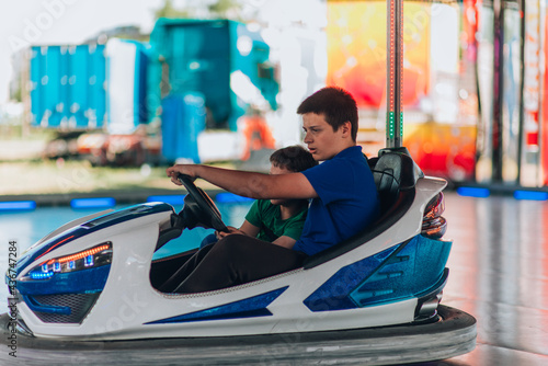The riding cars on a fun fair dodgem attraction