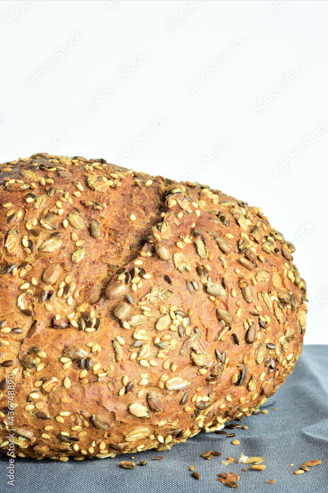 Multigrain bread on a gray cloth and white background. Copy space. Multigrain bread on a gray cloth and white background. Copy space.
