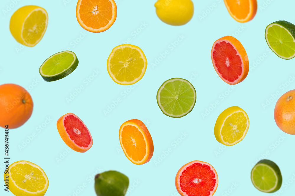 Minimal idea with fresh orange, lemon, lime and grapefruit sliced on pastel blue background.