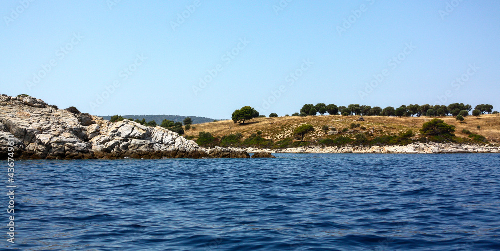 A sea coast somewhere in the region of Chalkidiki, Greece as seen from a boat. Shot in the year 2011.