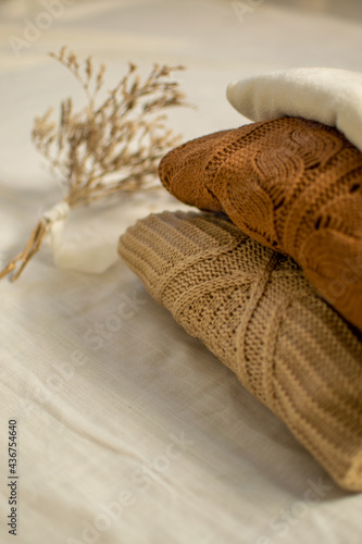 Brown, white linen on white canvas with decorative purple and brown branches 