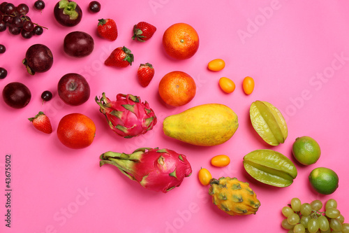 Fototapeta Naklejka Na Ścianę i Meble -  Many different delicious exotic fruits on pink background, flat lay