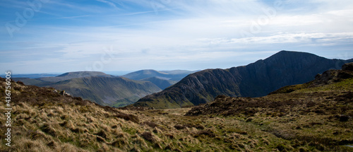 a view looing down in the crater of Cadair Idris with a mountain view behind it photo