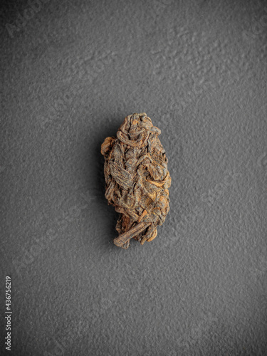 Pu-erh leaves in bud on dark gray background Lao Cha Tou top view