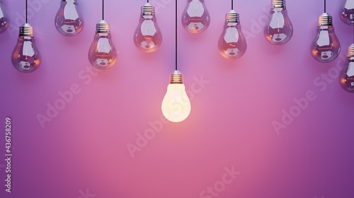 Hanging light bulbs on purple background with one illuminated and space for text	

