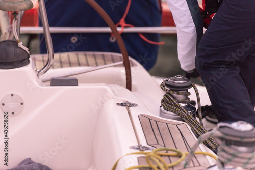 We wind the mooring lines on the winch on the yacht. The sailor throws the aft mooring line when mooring.