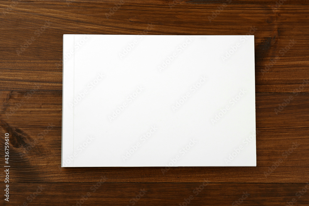 Blank paper brochure on wooden table, top view. Mockup for design Blank paper brochure on wooden table, top view. Mockup for design