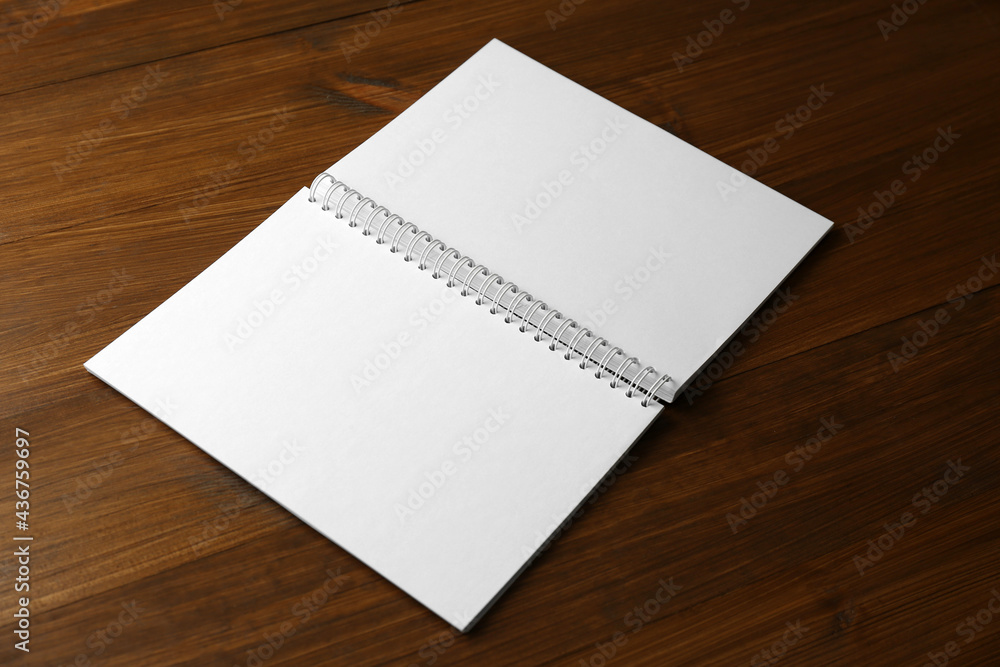 Blank paper brochure on wooden table. Mockup for design Blank paper brochure on wooden table. Mockup for design