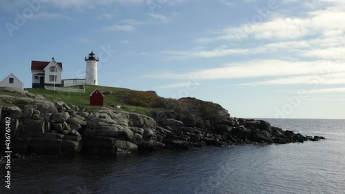 Classic New England lighthouse on a sunny fall day.  photo