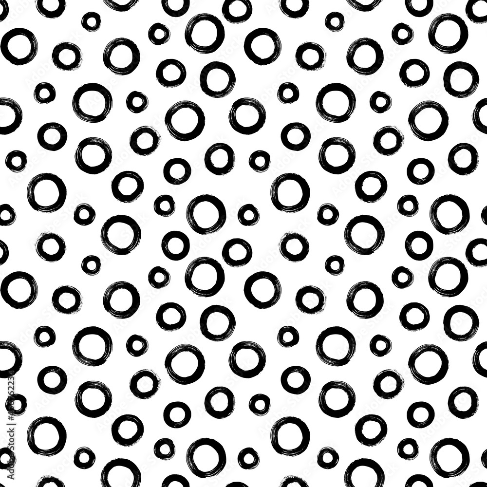 Black and white seamless pattern with rings in brush stroke technique. Abstract background with hand painted circles. Black and white seamless pattern with rings in brush stroke technique. Abstract background with hand painted circles.