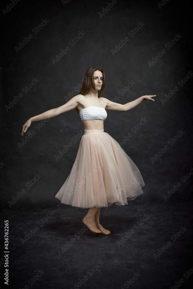 Young girl in white top and peach skirt dancing Young girl in white top and peach skirt dancing
