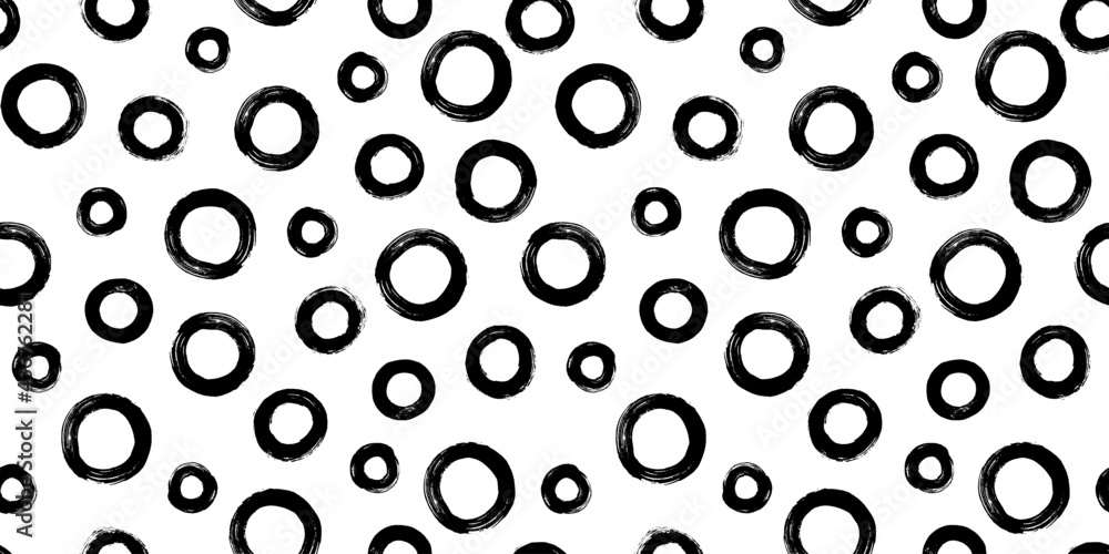 Black and white seamless pattern with rings in brush stroke technique. Abstract background with hand painted circles. Black and white seamless pattern with rings in brush stroke technique. Abstract background with hand painted circles.