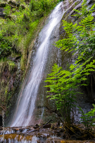 Water flows through a mountain waterfall
