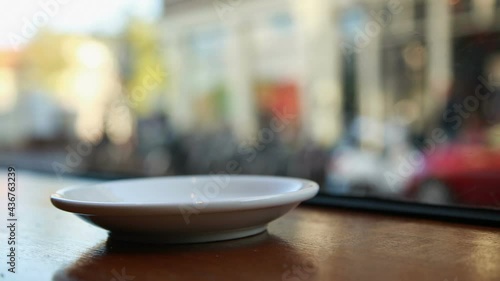 A coffee cup in an Amsterdam coffeeshop is lifted