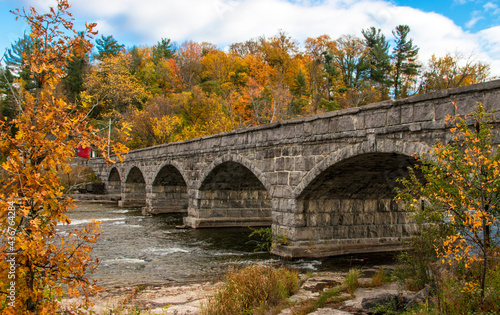 Beautiful old stone stone bridge in autumn. The historic Pakenham five arched stone bridge spans the Mississippi River in Canada. Built ca. 1901, it's the only one of its kind outside of Russia.