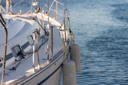 Yacht side with mooring fenders. The side of the yacht in the parking lot is made from the stern side. Yacht and sea.