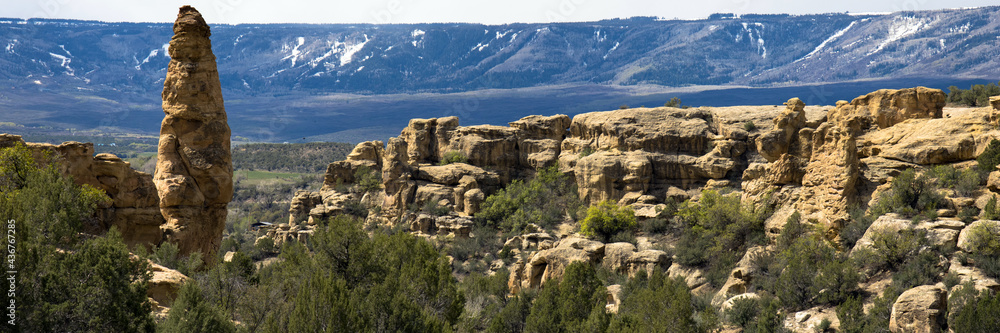 Panorama of Grand Mesa in Colorado, showing long views and a dramatic tall rock spike