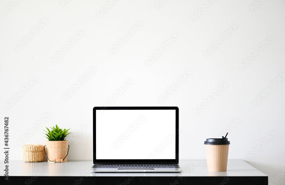 Laptop computer with blank screen in office Laptop computer with blank screen in office