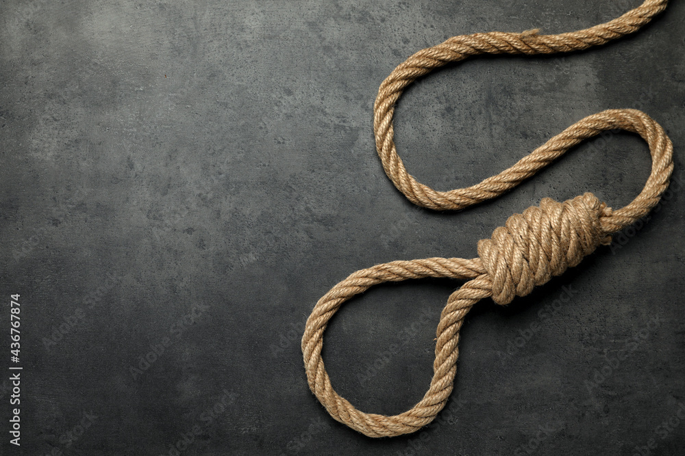 Rope noose with knot on grey table, top view. Space for text