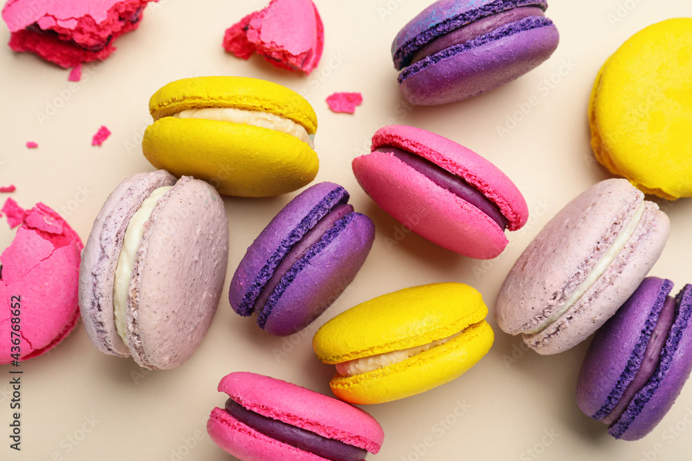 Delicious colorful macarons on beige background, flat lay Delicious colorful macarons on beige background, flat lay