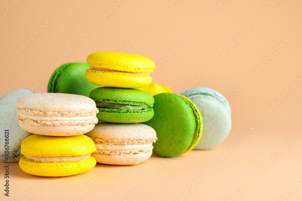 Delicious fresh colorful macarons on beige background Delicious fresh colorful macarons on beige background