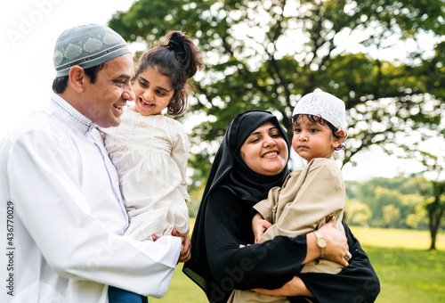 Muslim family having a good time outdoors photo