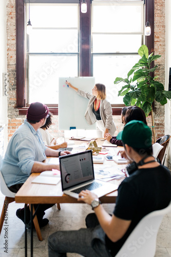 Wallpaper Mural Businesswoman writing on a board in the meeting room Torontodigital.ca