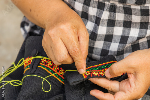 Female seamstress Embroidering a pattern of fabric.