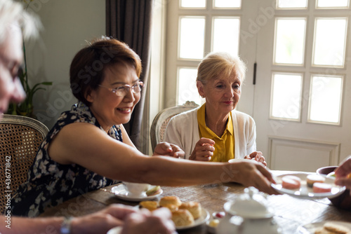 Elderly people having tea party together